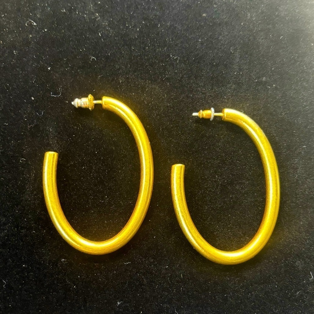 Large gold tone hoop earrings pierced ear